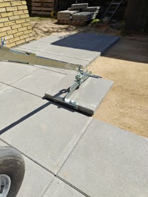 Eight shirts arranged on table in black, olive, grey, blue, white, red, mustard, and green.