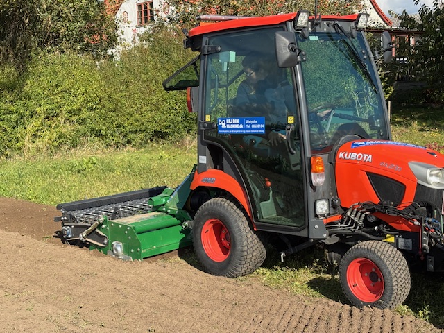 Eight shirts arranged on table in black, olive, grey, blue, white, red, mustard, and green.