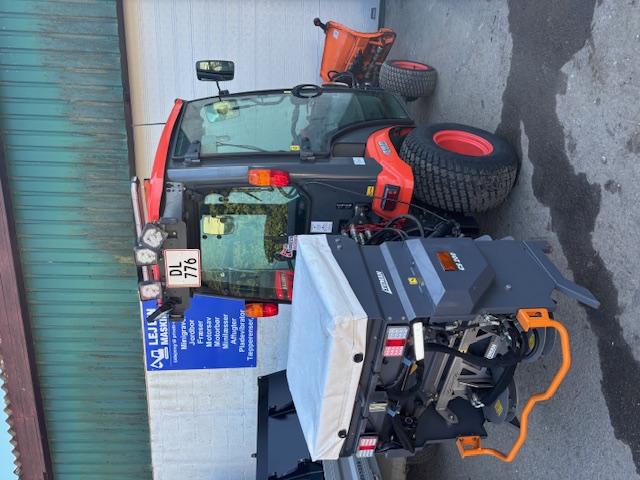 Eight shirts arranged on table in black, olive, grey, blue, white, red, mustard, and green.